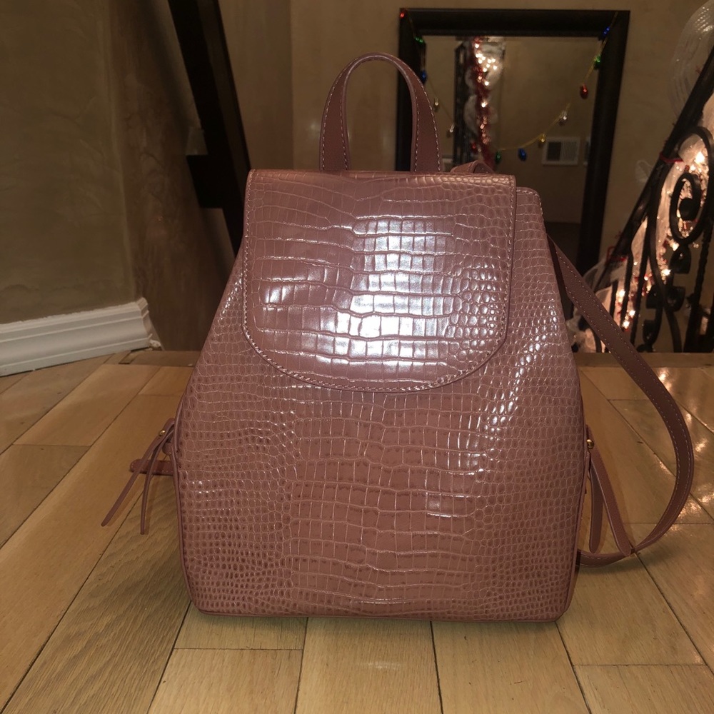 Mauve colored faux leather backpack